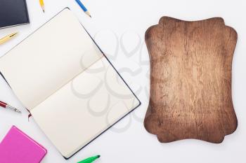 paper notebook and school supplies at white background