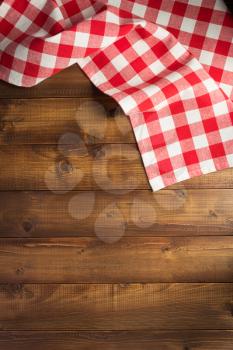 checked table cloth at wooden  surface background, top view