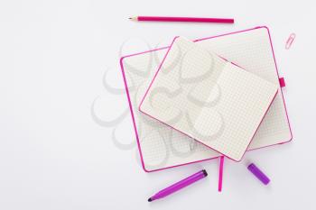 notebook and pencil  at white paper background, top view