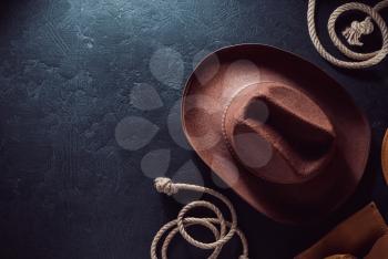 cowboy hat on black table wooden background, top view