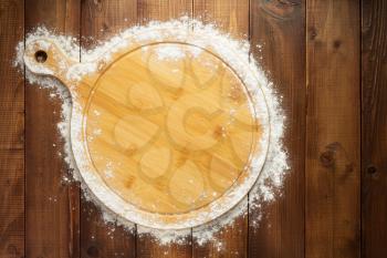 wheat flour on wooden background, top view