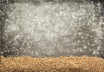wheat grains at wooden background, top view