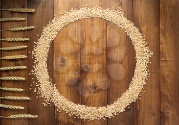 wheat grains on wooden background, top view