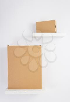 cardboard box on wooden shelf at white background