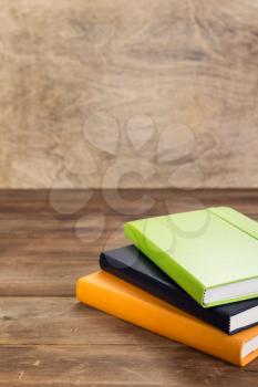 notebook or book at wooden table background