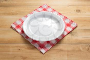 plate and napkin cloth at rustic wooden plank board table background