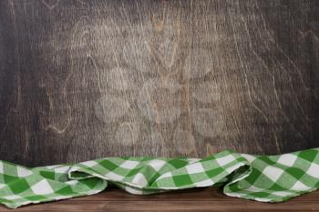 cloth napkin at rustic table in front, wooden plank board background