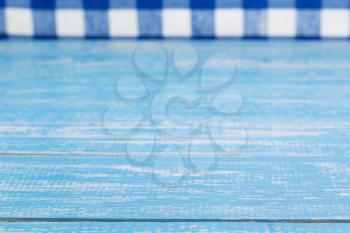rustic wooden table in front and cloth napkin, plank board background