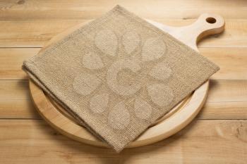 pizza cutting board and napkin at rustic wooden table plank background