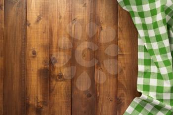 checked table cloth at wooden  surface background, top view