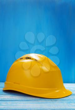 construction helmet on wooden table background texture