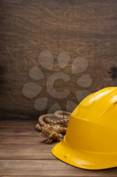 construction helmet on wooden table background texture