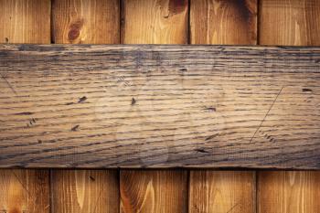 aged wooden nameplate at wood board background texture surface