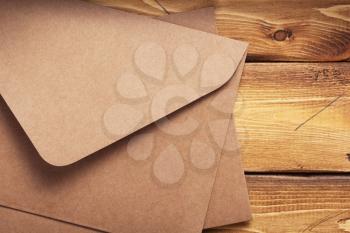 old cardboard postal envelope at aged wooden background plank board texture