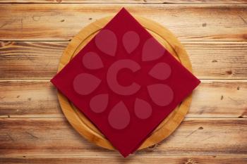 table cloth napkin and pizza cutting board on wooden background texture