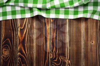 cloth napkin at old wooden board table background, top view