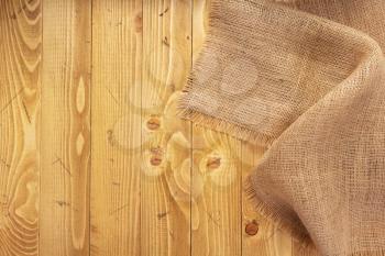 burlap hessian sacking texture on old wooden background, table surface