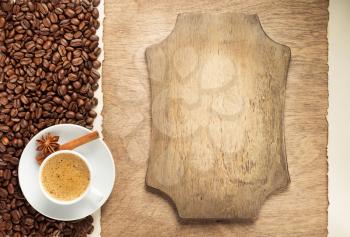 cup of coffee and beans on wooden background, top view