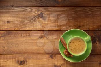 cup of coffee on wooden background, top view