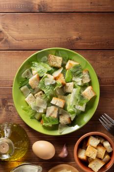 caesar salad in plate at wooden  background