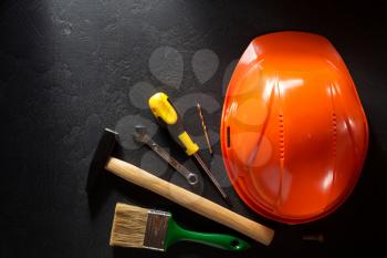 hardhat and tools  on black background