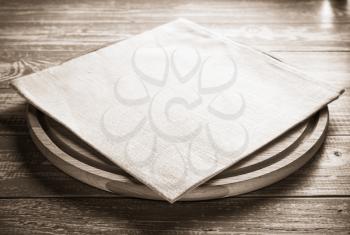 napkin at cutting board on wooden background