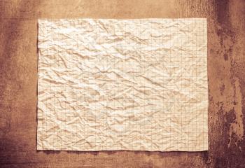 wrinkled paper at wall background