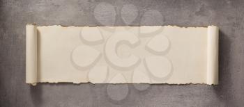 parchment scroll at concrete wall surface background