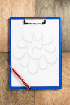 paper clipboard at wooden background texture