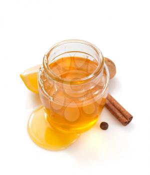 glass jar of honey isolated on white background