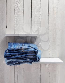 blue jeans on wooden shelf background