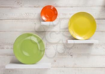 plate at shelves on white wooden plank background
