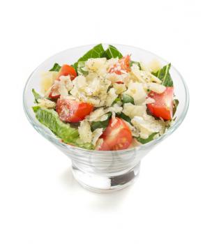 caesar salad in glass bowl isolated on white background