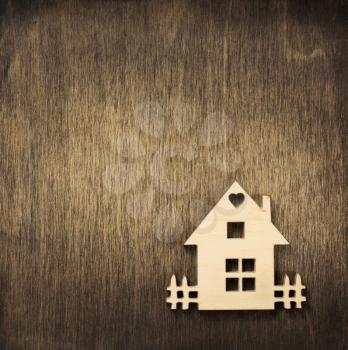 toy house at wooden background surface