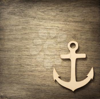 toy anchor at wooden background surface