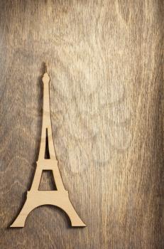 wooden eiffel tower toy at plywood background surface