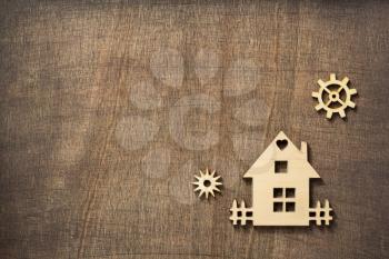 wooden toy house at wooden background surface