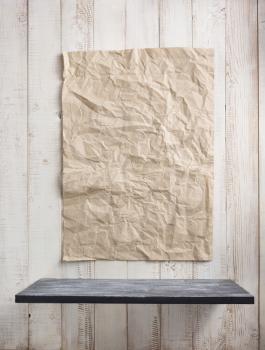 paper and wooden shelf at white wall background texture