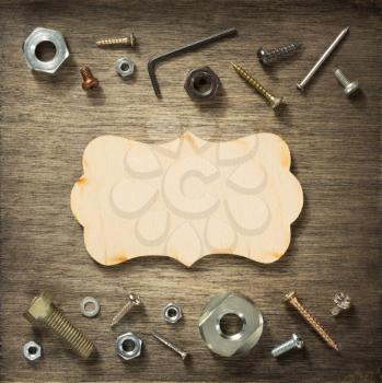 hardware tools and screws at wooden background