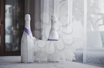 Bottles with champagne decorated with a pattern from flowers.