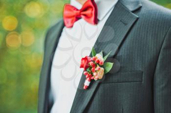 The man in a red butterfly and with a buttonhole.