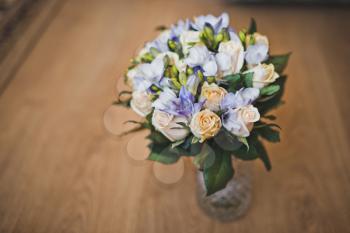 The wedding bunch of flowers lies in a vase on a table.