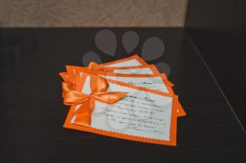 The invitation to wedding in the form of a card with a bow.