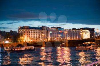 Beautiful views of the night city from the motor ship going on the water areas of the Neva River and channels.