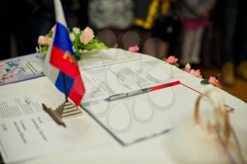 Table with a flag of Russia and documents with the handle.