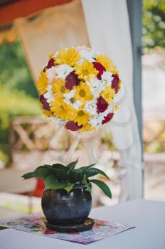 Vase from white, red and yellow flowers.