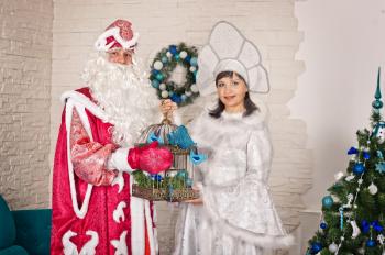 Father Frost and the Snow Maiden give gifts.
