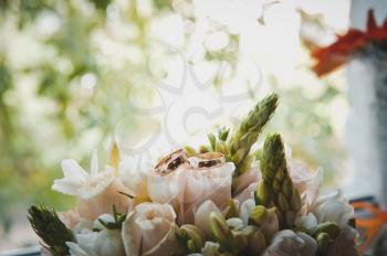 Wedding rings on roses.