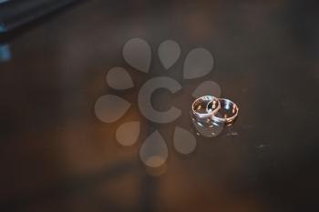 Wedding rings on glass.