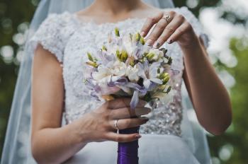 The bride holds a bunch of flowers.